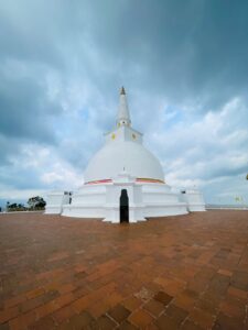 Experience the serene beauty of Ruwanweli Pagoda in Anuradhapura, Sri Lanka with dramatic clouds above.