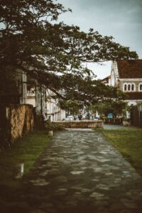 Explore the historic charm of Galle Fort with this scenic image showcasing timeless architecture and lush greenery.